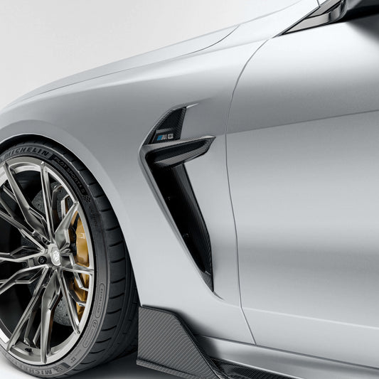 BMW M8 F92 with a carbon fiber vent close-up on a white background