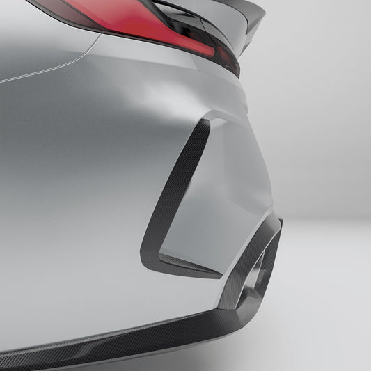 Close-up of a car's rear bumper with carbon fiber texture on a gray background