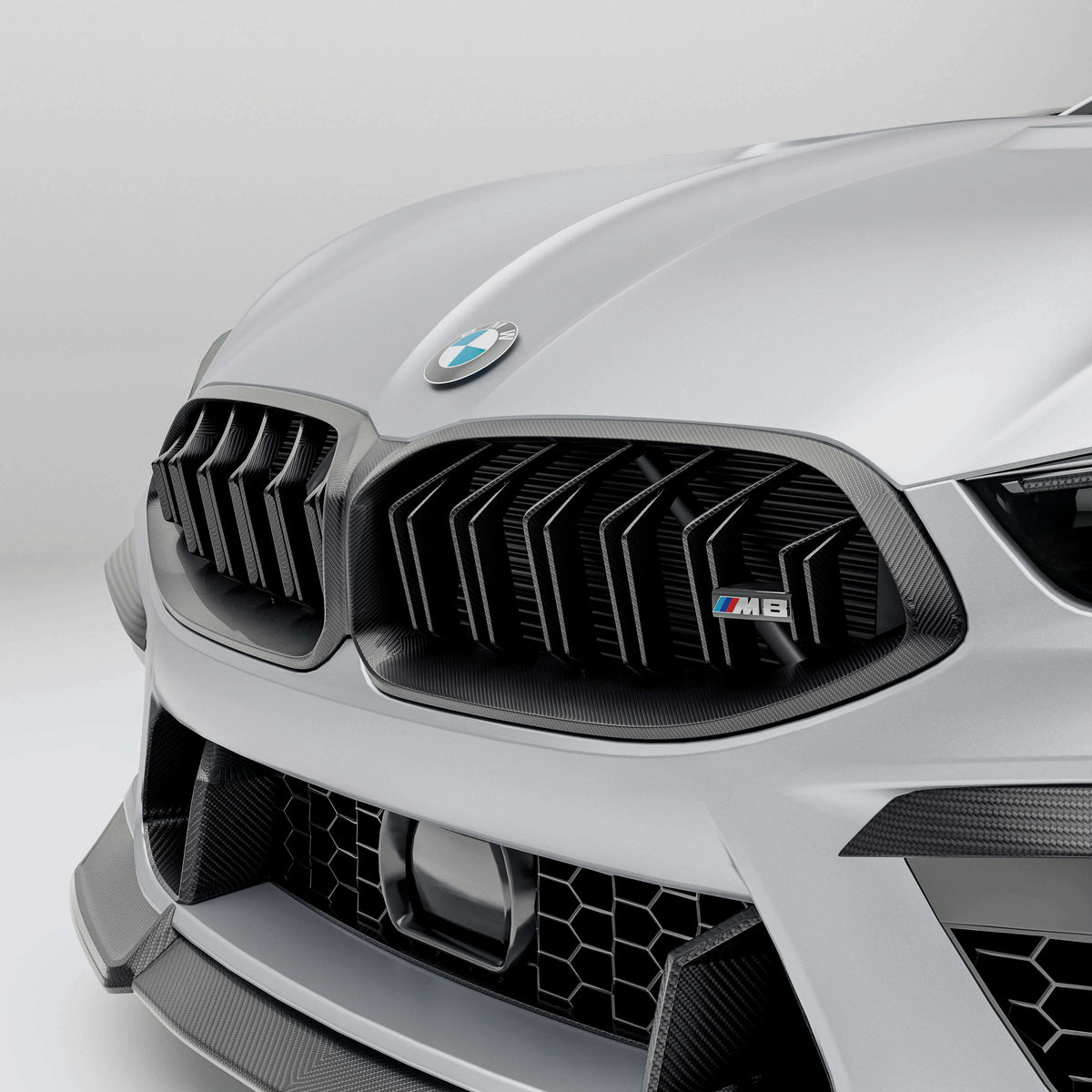 BMW M8 F92  with a carbon fiber grille front-angle on a white background