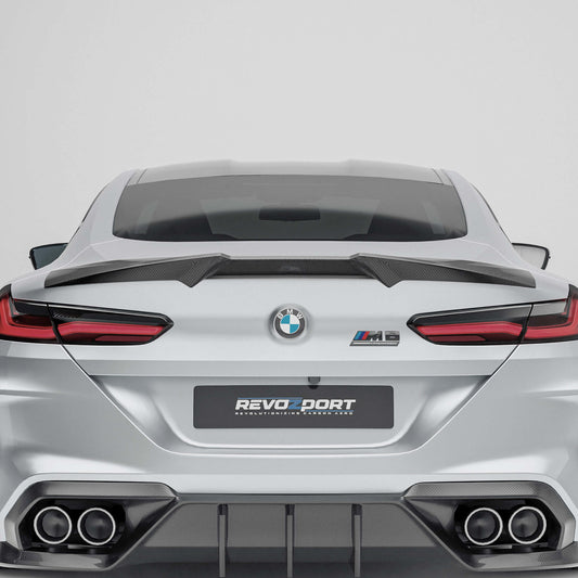 BMW M8 F92  with a carbon fiber rear spoiler close-up on a white background